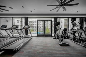 A gym with treadmills and elliptical machines at Regatta Sloans Lake Apartments, Denver 80204